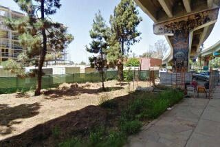 The proposed Barrio Logan community garden might go beneath the San Diego-Coronado Bridge, just east of the Mercado del Barrio project, seen here under construction in 2012.