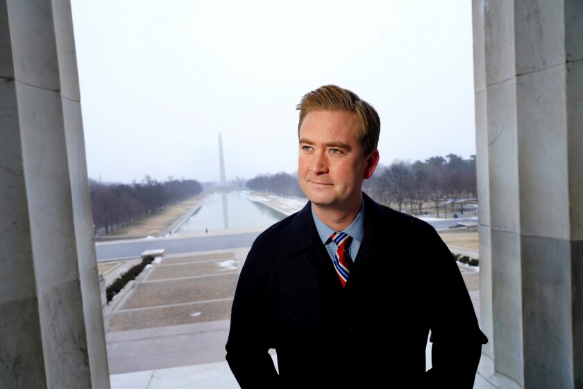 Peter Doocy poses for a photo with the Washington Monument in the background.