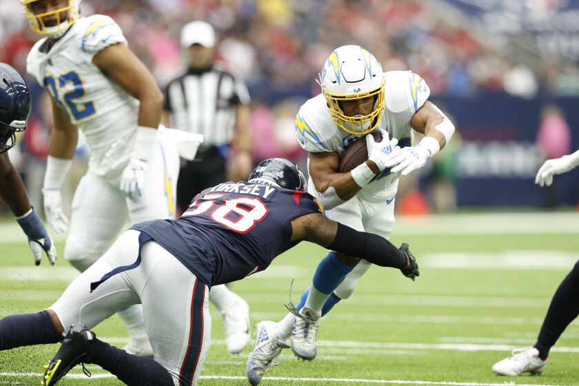 Los Angeles Chargers running back Austin Ekeler (30) carries the ball during an NFL football game against the Houston Texans on Sunday, October 2, 2022, in Houston. (AP Photo/Matt Patterson)