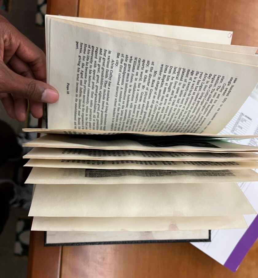 A partially opened book on a table.