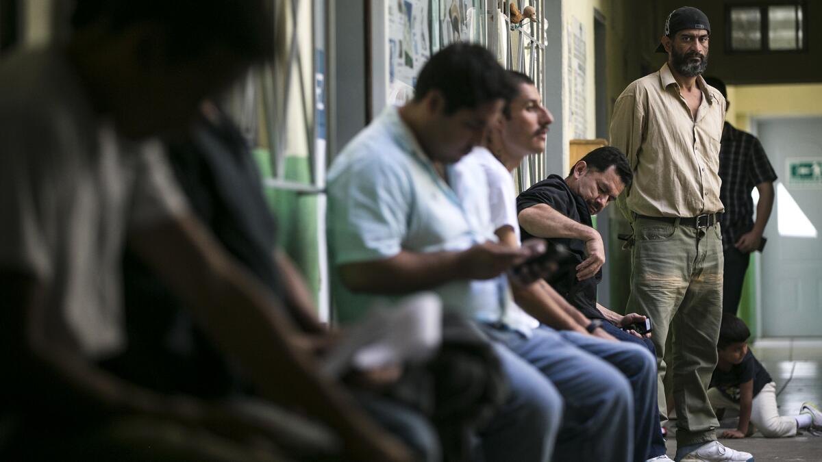 Immigrants seeking a way into the United States wait to speak to attorneys at a two-day clinic at a shelter in Tijuana.