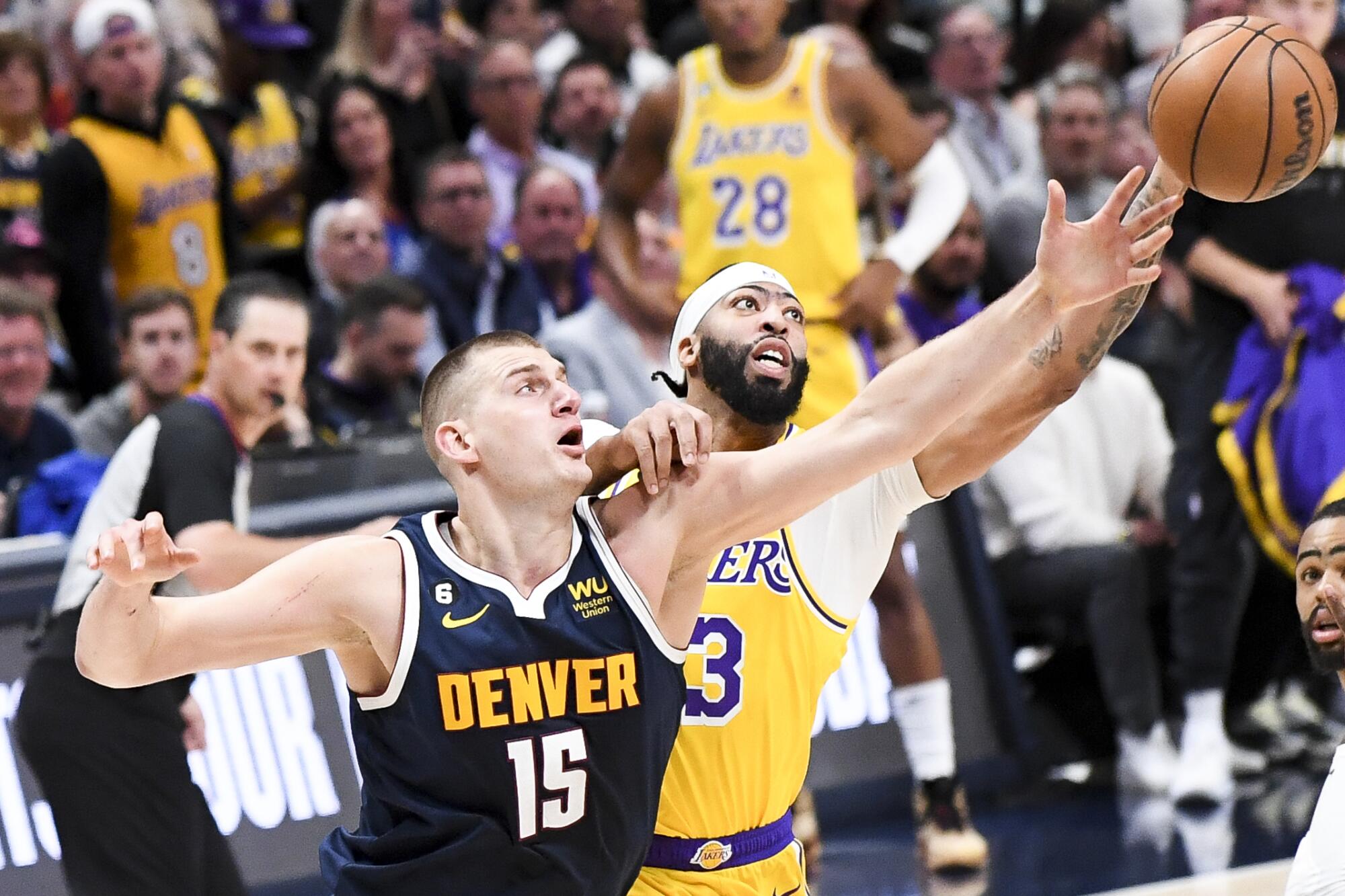 Denver Nuggets center Nikola Jokic, left, and Lakers forward Anthony Davis battle for the rebound.
