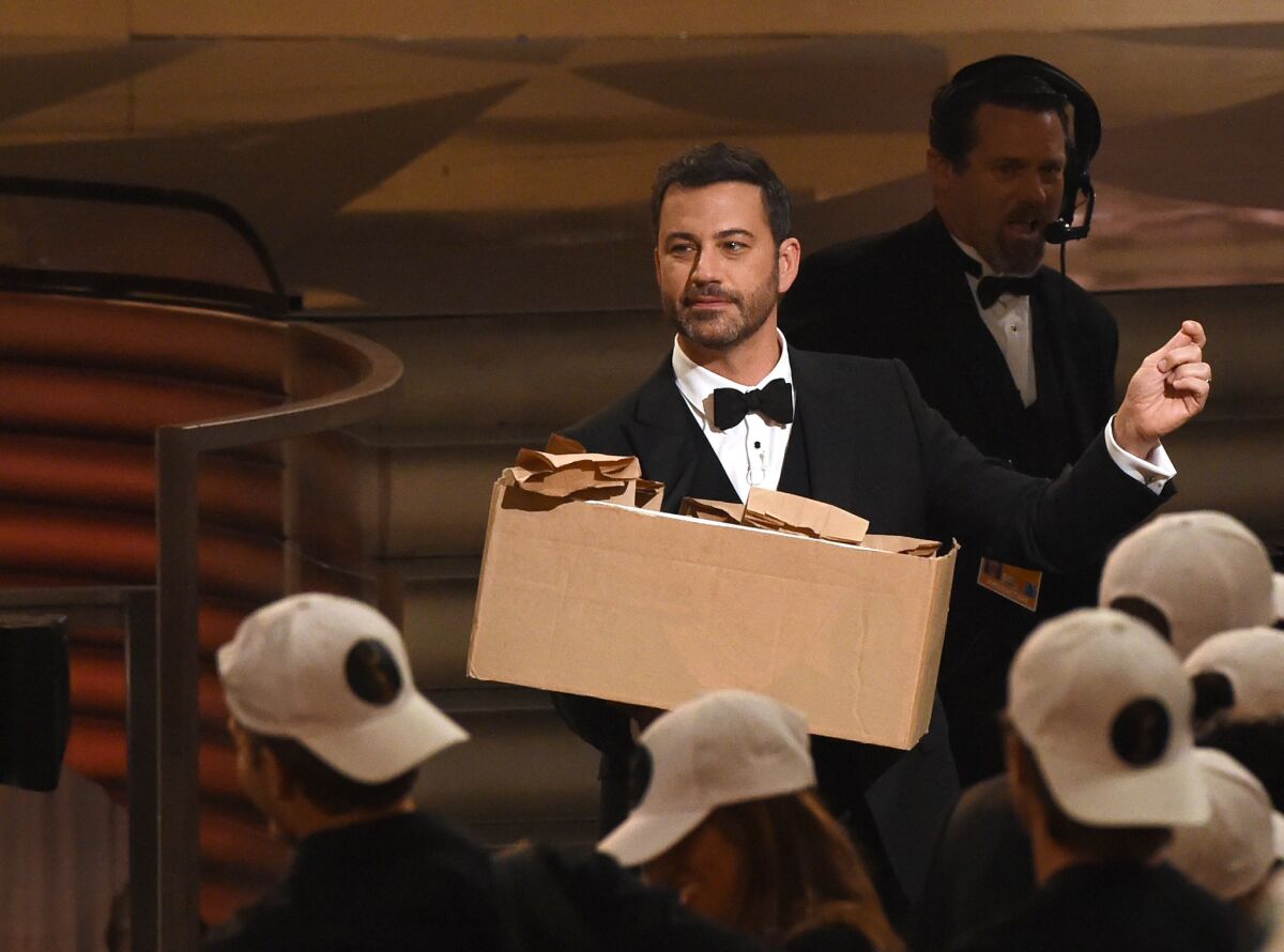 Host Jimmy Kimmel hands out peanut butter and jelly sandwiches during the 68th Emmy Awards show in Los Angeles.