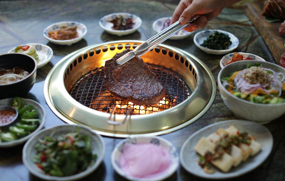 A ribeye on the grill at Jeong Yuk Jeom in Koreatown.