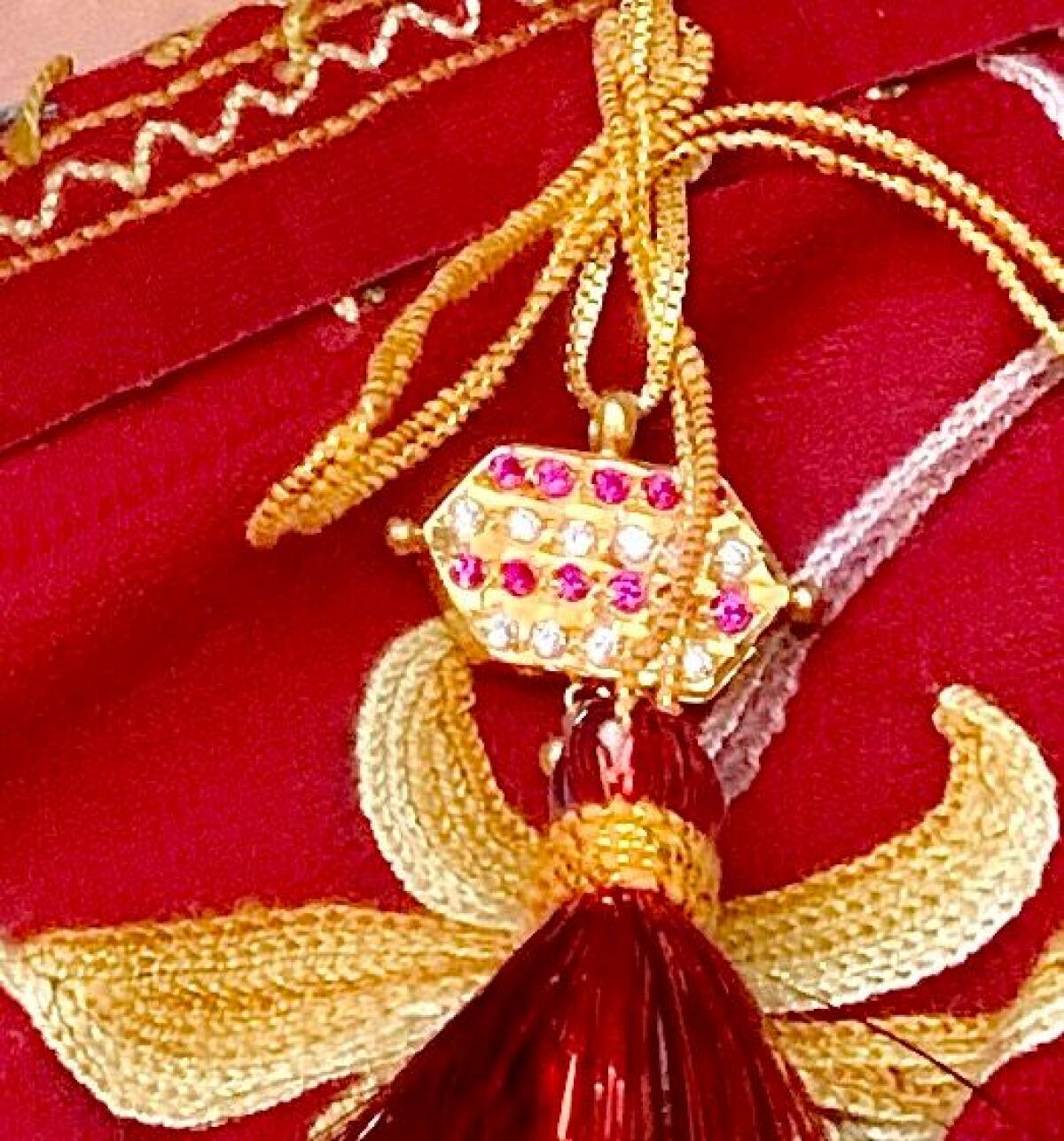 A gold diamond and ruby-encrusted dejhoor.