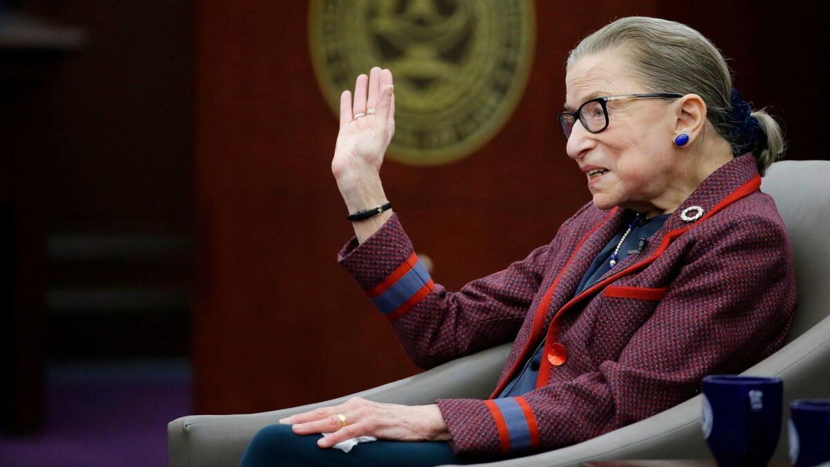 Supreme Court Justice Ruth Bader Ginsburg waves goodbye to those who came to listen and participate in her "fireside chat" in Bristol, R.I. on Jan. 30.