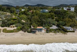 Malibu, CA - May 31: The owners of the properties at 27910 Pacific Coast Highway, center, and 27920 Pacific Coast Highway, left, installed fences, driveways, dumpsters and landscaping along the highway to obscure the public easement to Escondido Beach on Wednesday, May 31, 2023 in Malibu, CA. (Brian van der Brug / Los Angeles Times)