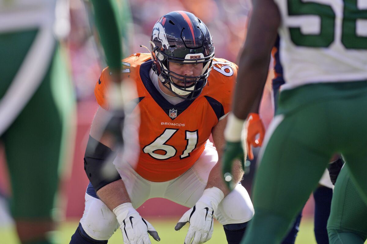 FILE - In this Sunday, Sept. 26, 2021, file photo, Denver Broncos offensive guard Graham Glasgow (61) lines up against the New York Jets during the first half of an NFL football game in Denver. Glasgow says the next time his heart starts racing in a game he’ll head straight to the sideline. He stuck it out in the season opener and only learned afterward that he was risking a stroke by playing through an atrial fibrillation episode. (AP Photo/David Zalubowski, File)