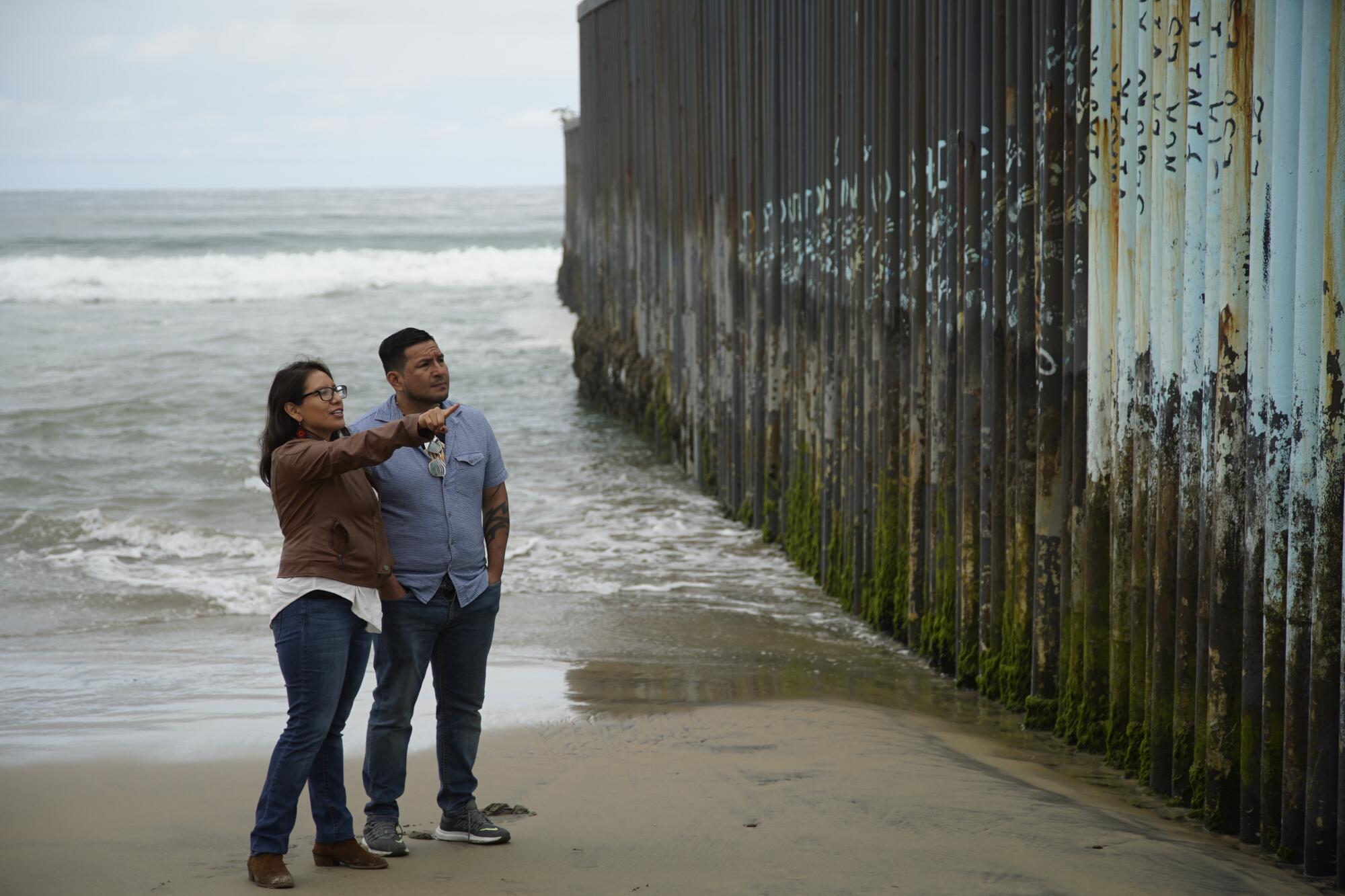 On her last day in Mexico, Dulce Garcia and her brother visit the border fence at Playas de Tijuana