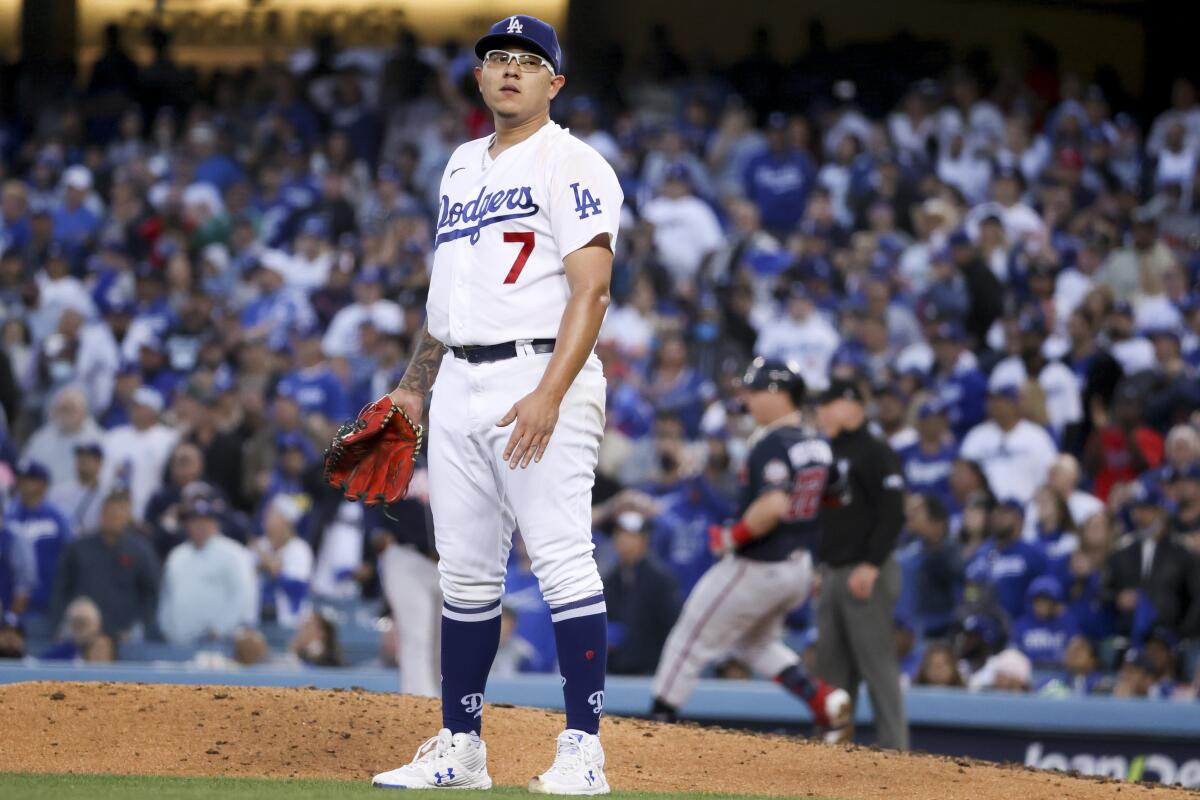 Dodgers starting pitcher Julio Urias reacts after a run-scoring single by Joc Pederson during the third inning.