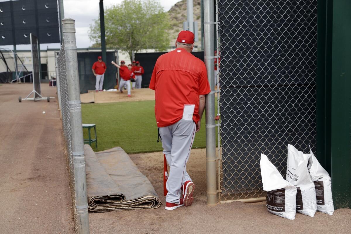 Angels Manager Mike Scioscia watches pitchers during spring training in Tempe, Ariz., on Feb. 23.