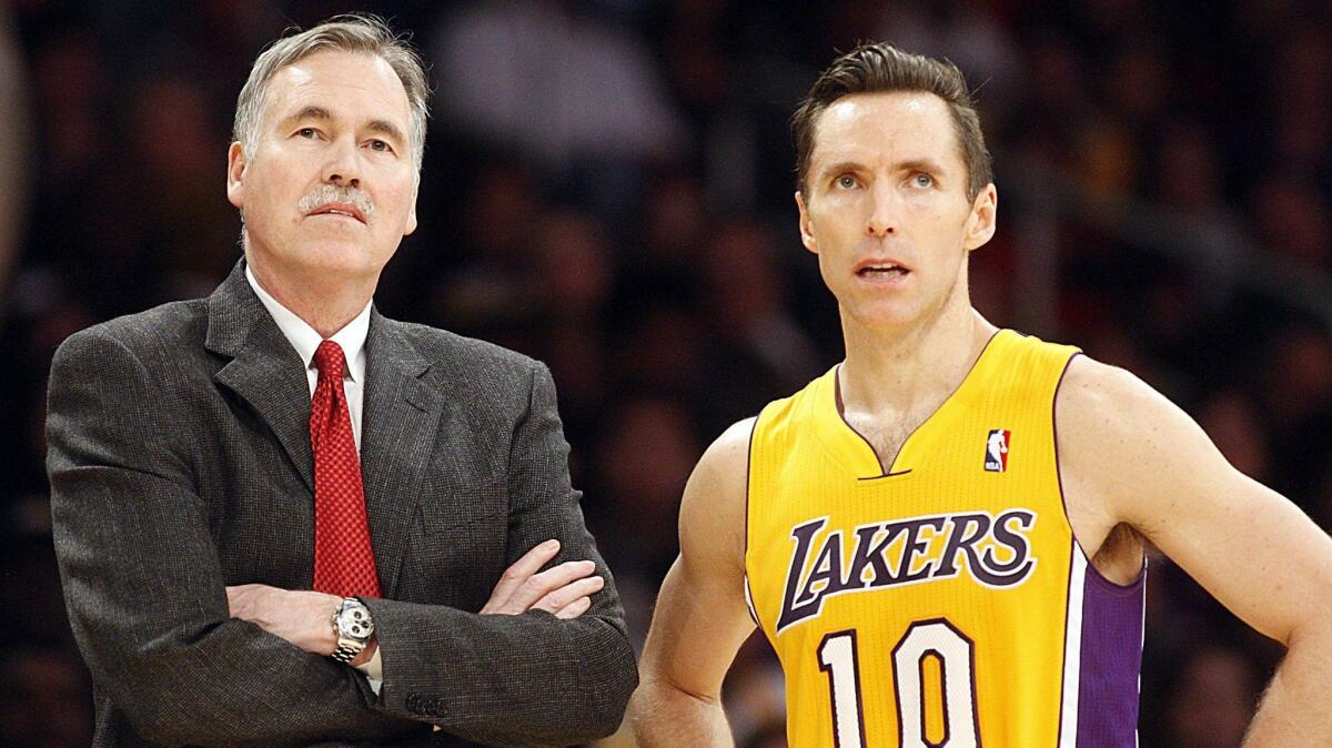 Mike D'Antoni, then Lakers coach, talks with point guard Steve Nash on Jan. 1, 2013.