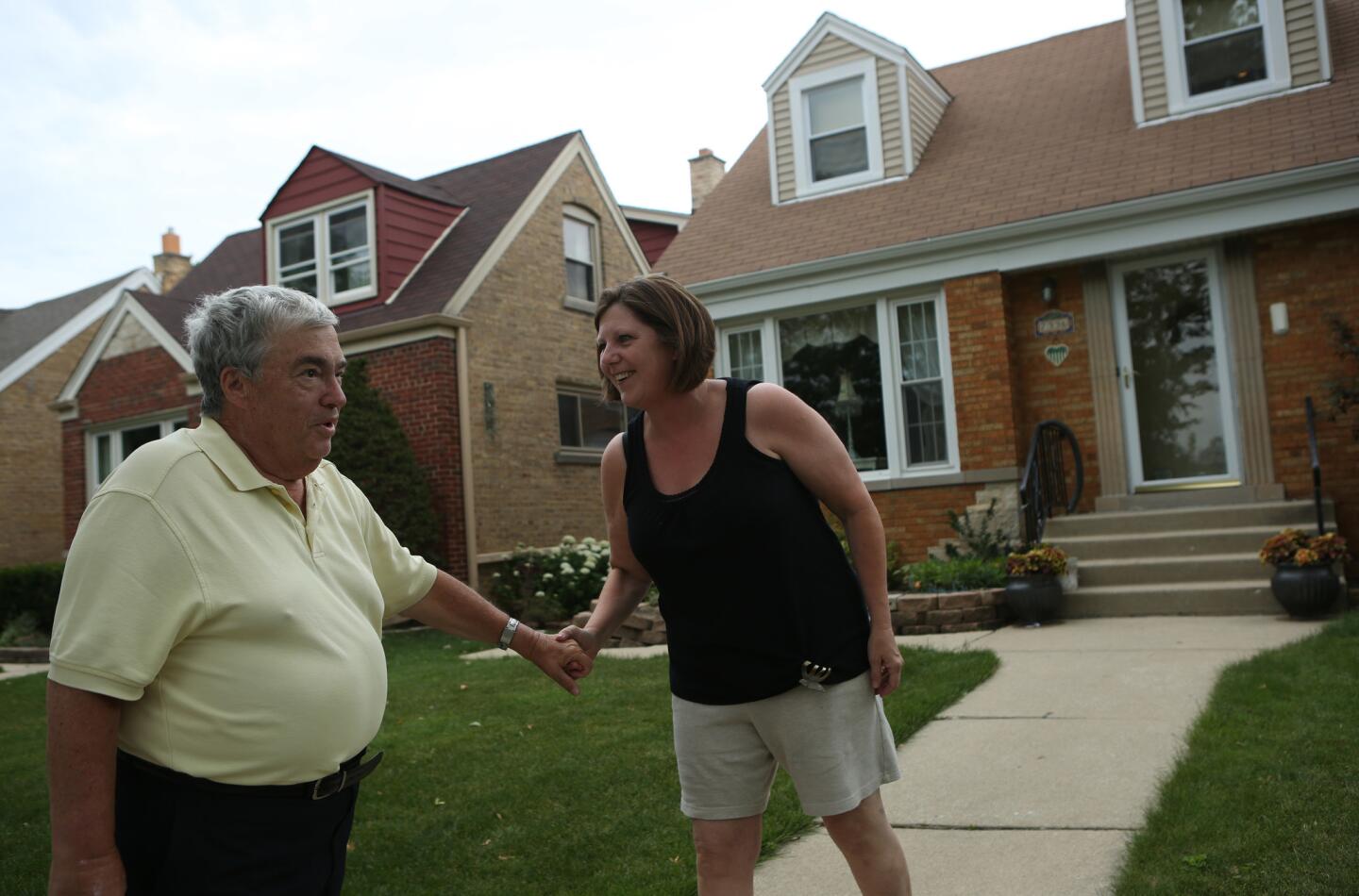 Kathy McDermott recognizes Jerry Krause as he tries to pick out his childhood home on Everell Avenue on June 21, 2012.