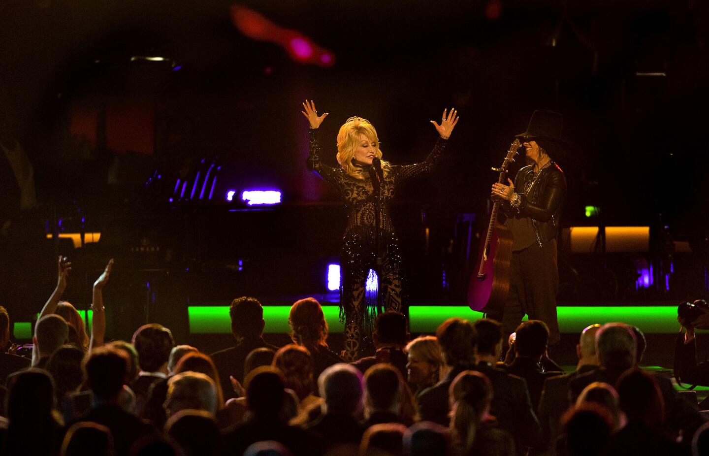 Dolly Parton acknowledges the crowd after performing with Linda Perry.