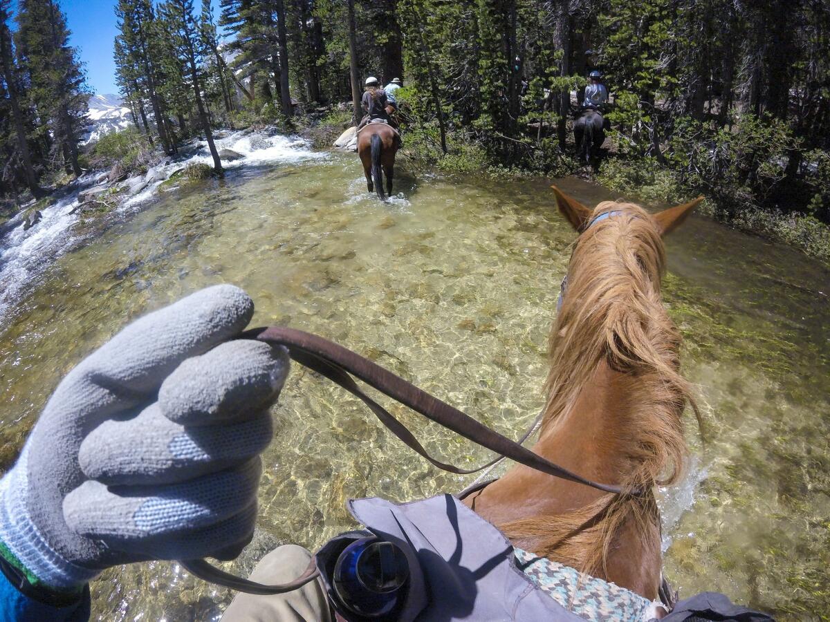 Guests and packers from Rock Creek Pack Station cross a creek near Davis Lake, in the Eastern Sierra.