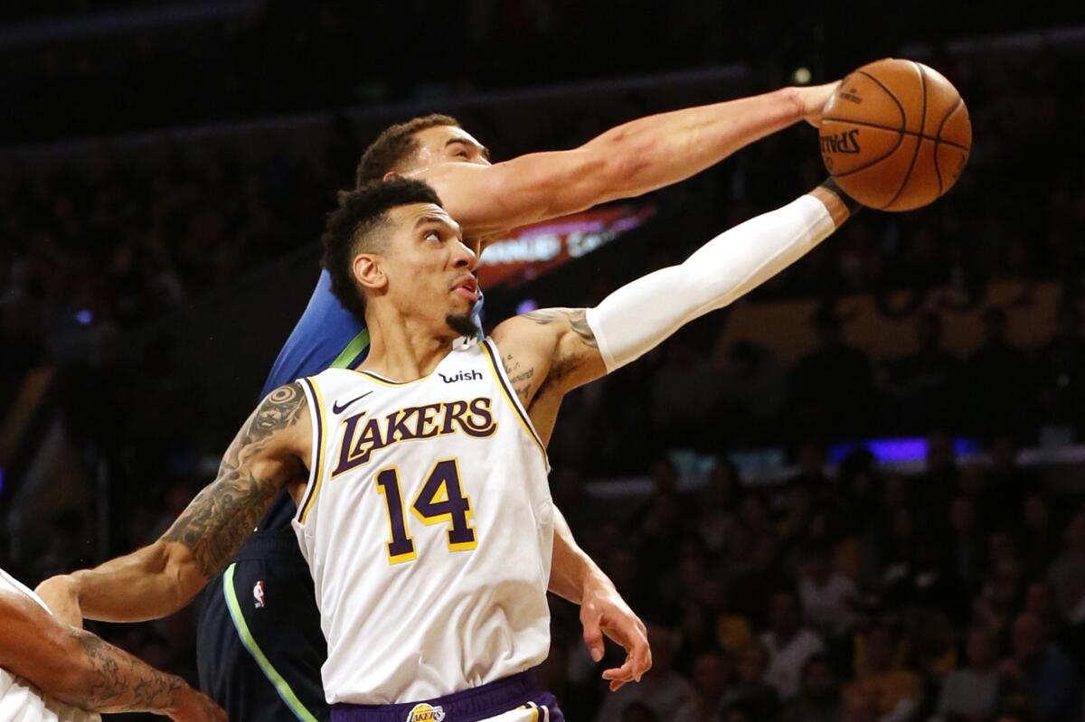 Lakers guard Danny Green tries to pull down a rebound against Mavericks forward Dwight Powell during a game on Dec. 1, 2019.