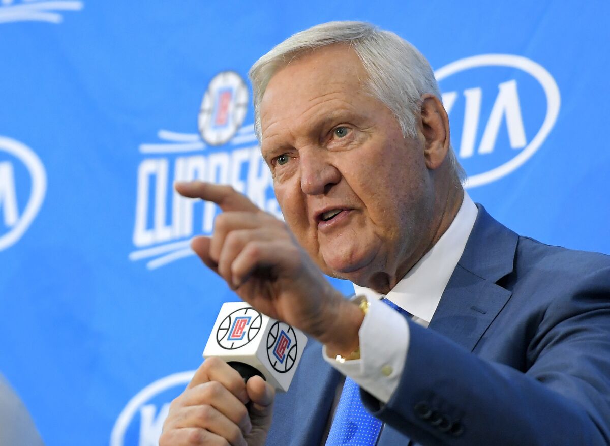  Jerry West points as he speaks during a news conference.