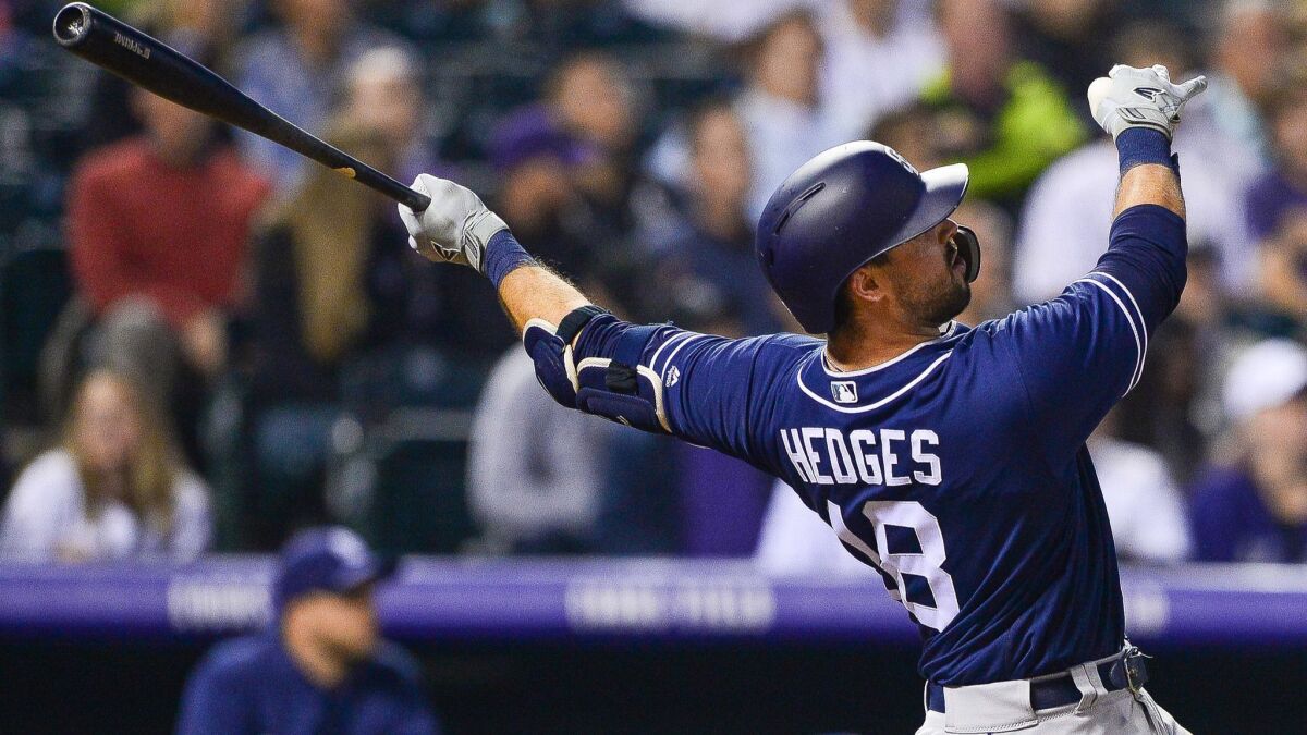 The Padres' Austin Hedges follows through on a sixth-inning solo home run against the Colorado Rockies at Coors Field on August 21, 2018 in Denver, Colorado.