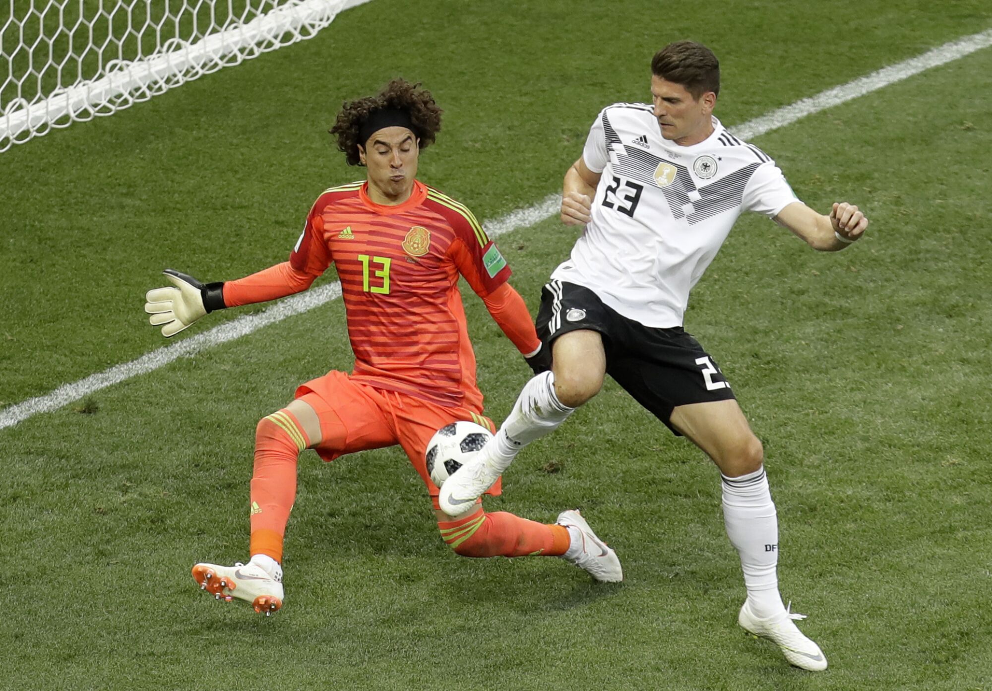 Mexico goalkeeper Guillermo Ochoa blocks Germany's Mario Gomez 