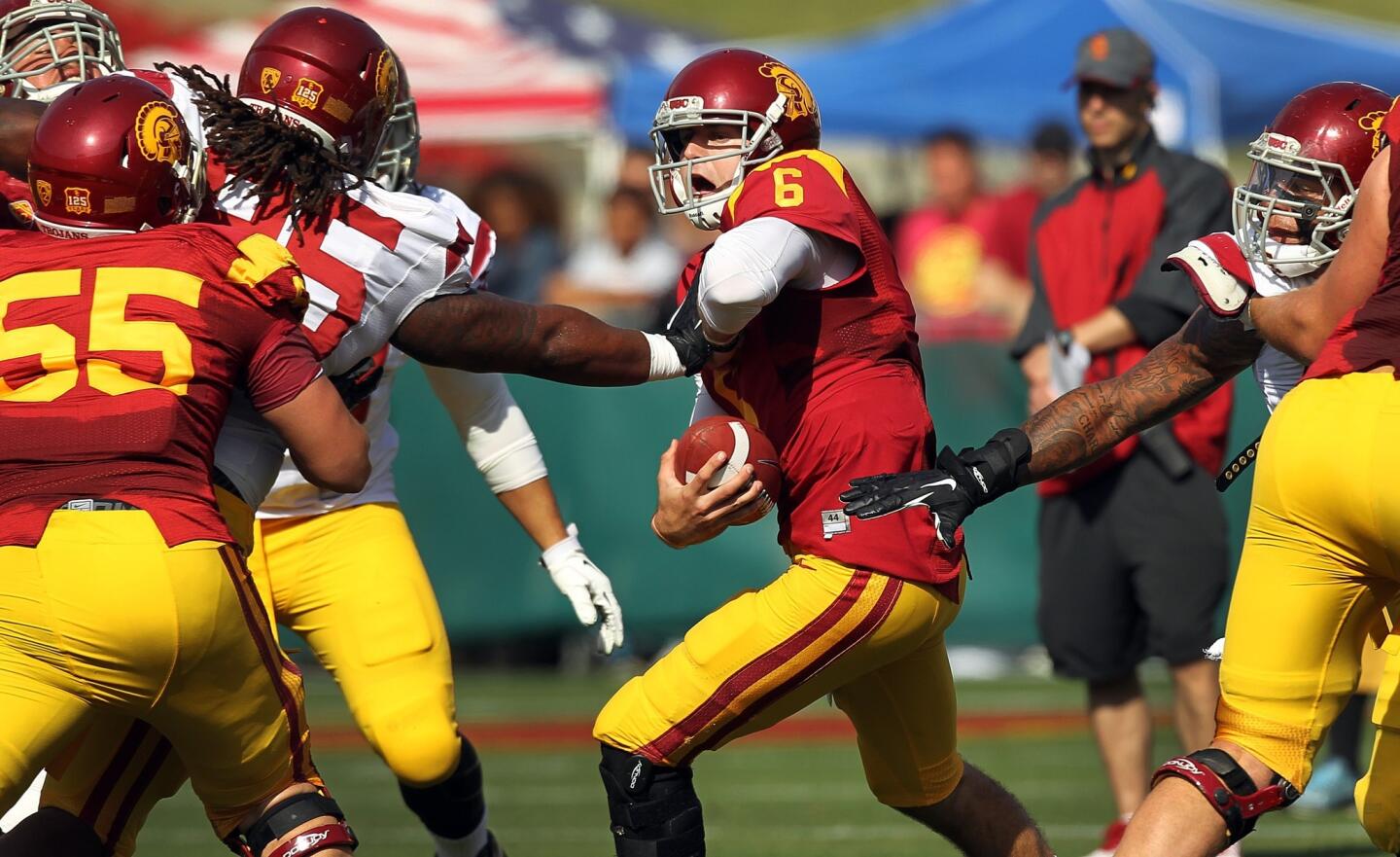 USC quarterback Cody Kessler tries to avoid being sacked during the Trojans' spring game at the Coliseum.