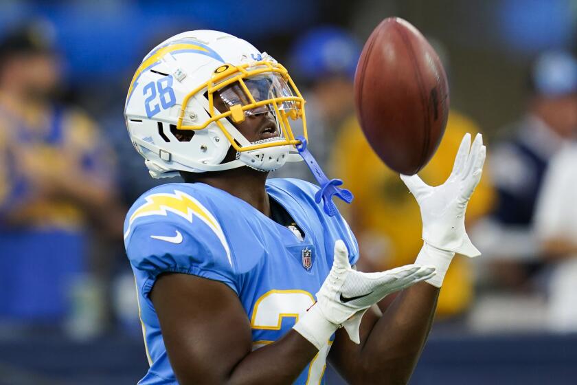 Los Angeles Chargers running back Isaiah Spiller (28) warms up.