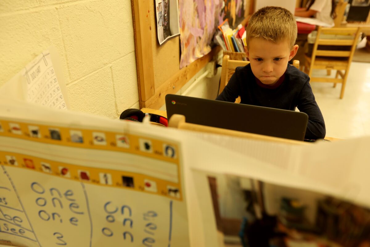 Kindergarten student Bobby, 6, works on his computer while attending class at Kigala Preschool in Santa Monica.
