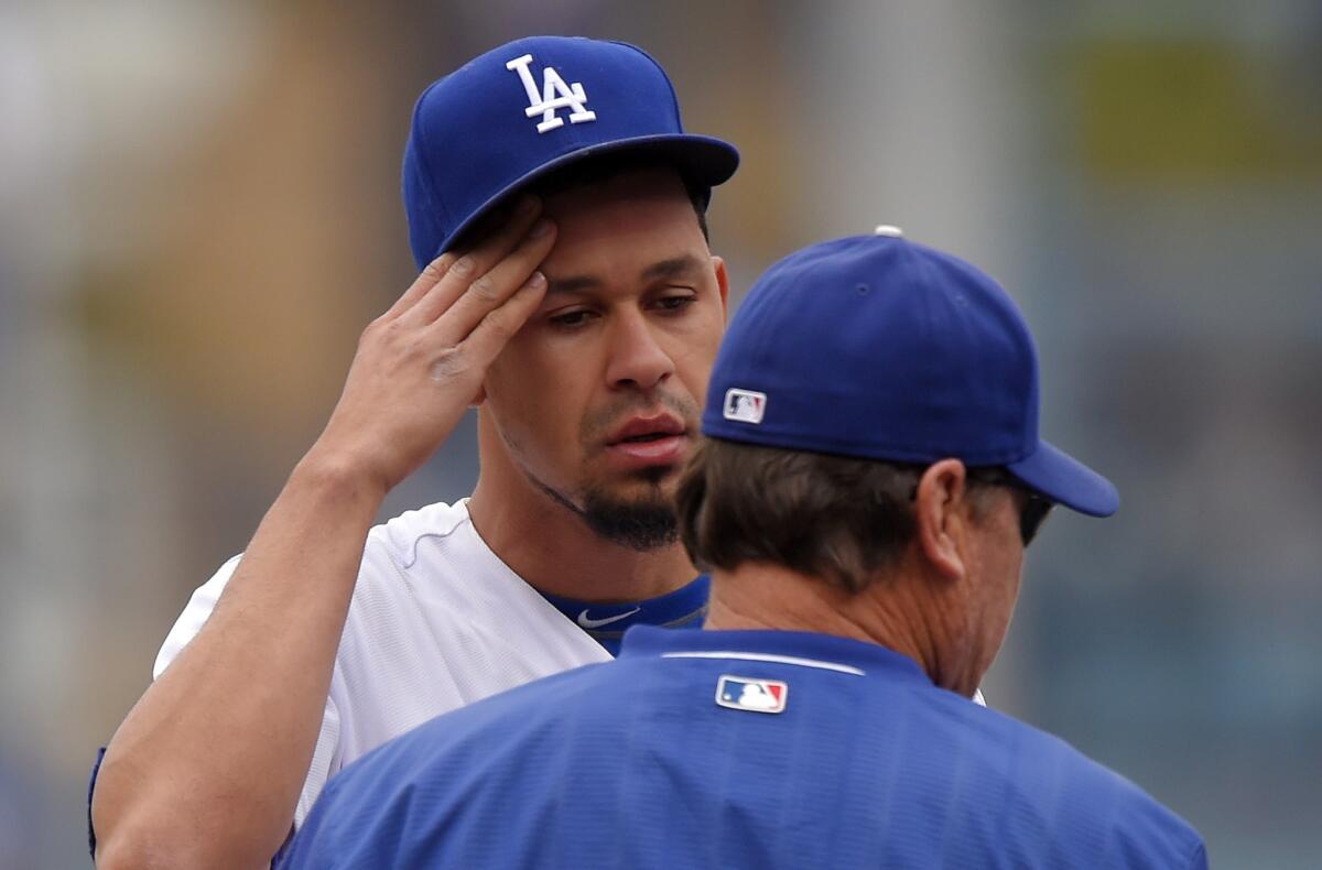 Dodgers pitcher Carlos Frias talks to pitching coach Rick Honeycutt during the first inning of a game Sunday against the Padres. Frias gave up 10 runs in four innings in the Dodgers' 11-3 loss.