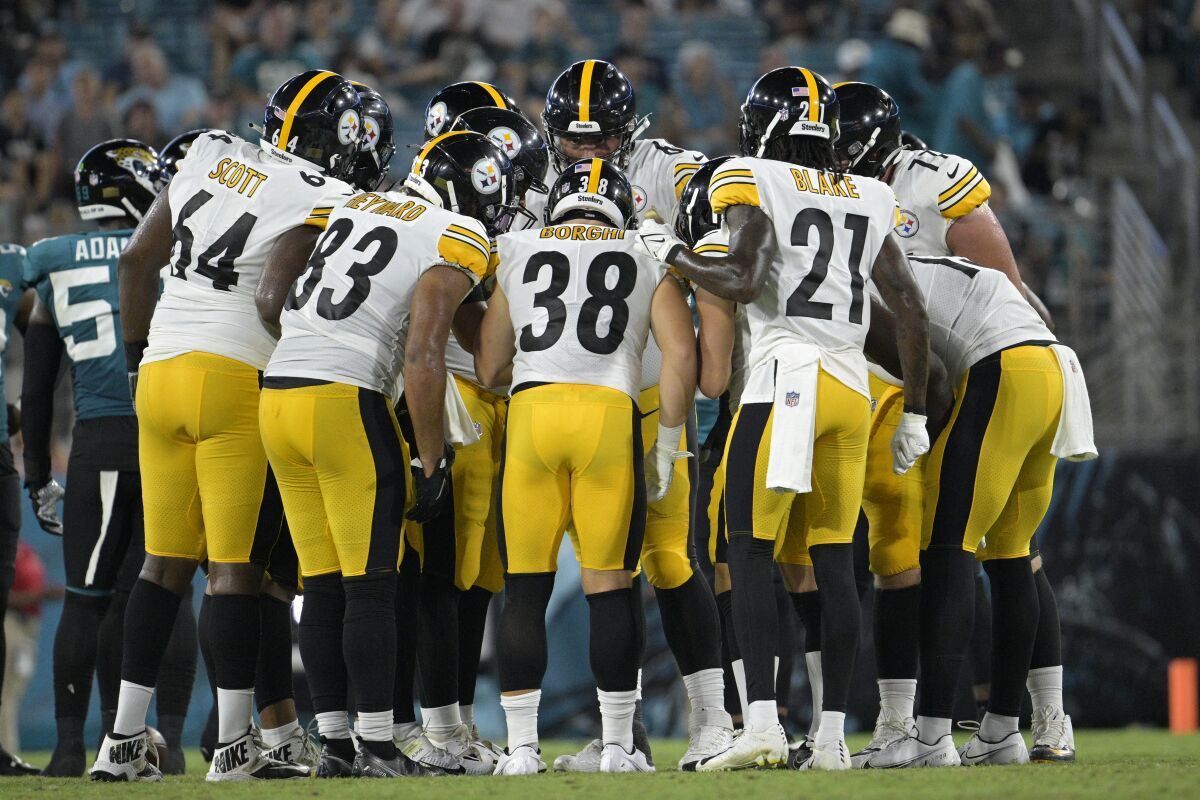 Pittsburgh Steelers offensive players huddle during the second half of a preseason NFL football game against the Jacksonville Jaguars, Saturday, Aug. 20, 2022, in Jacksonville, Fla. (AP Photo/Phelan M. Ebenhack)