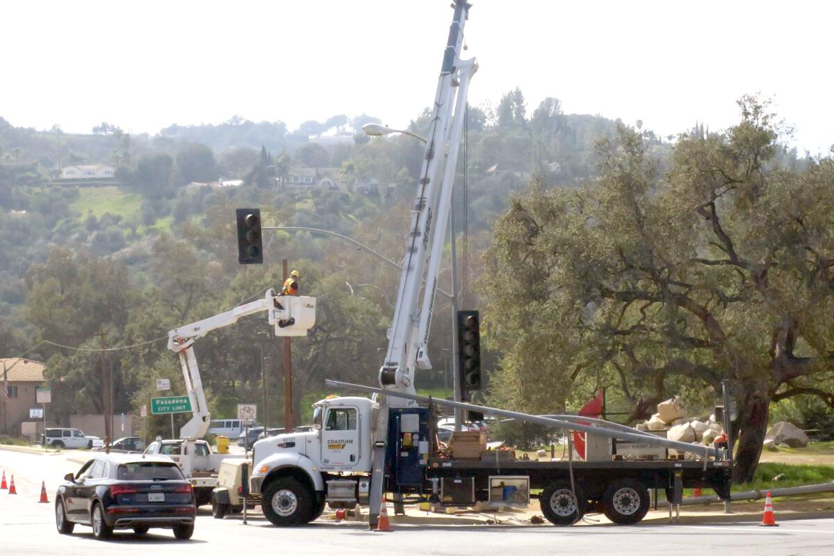 A crew closed traffic lanes Tuesday to install a protected left-hand turn signal for northbound traffic on Oak Grove at Berkshire Place. The new light should be operational by mid-March.