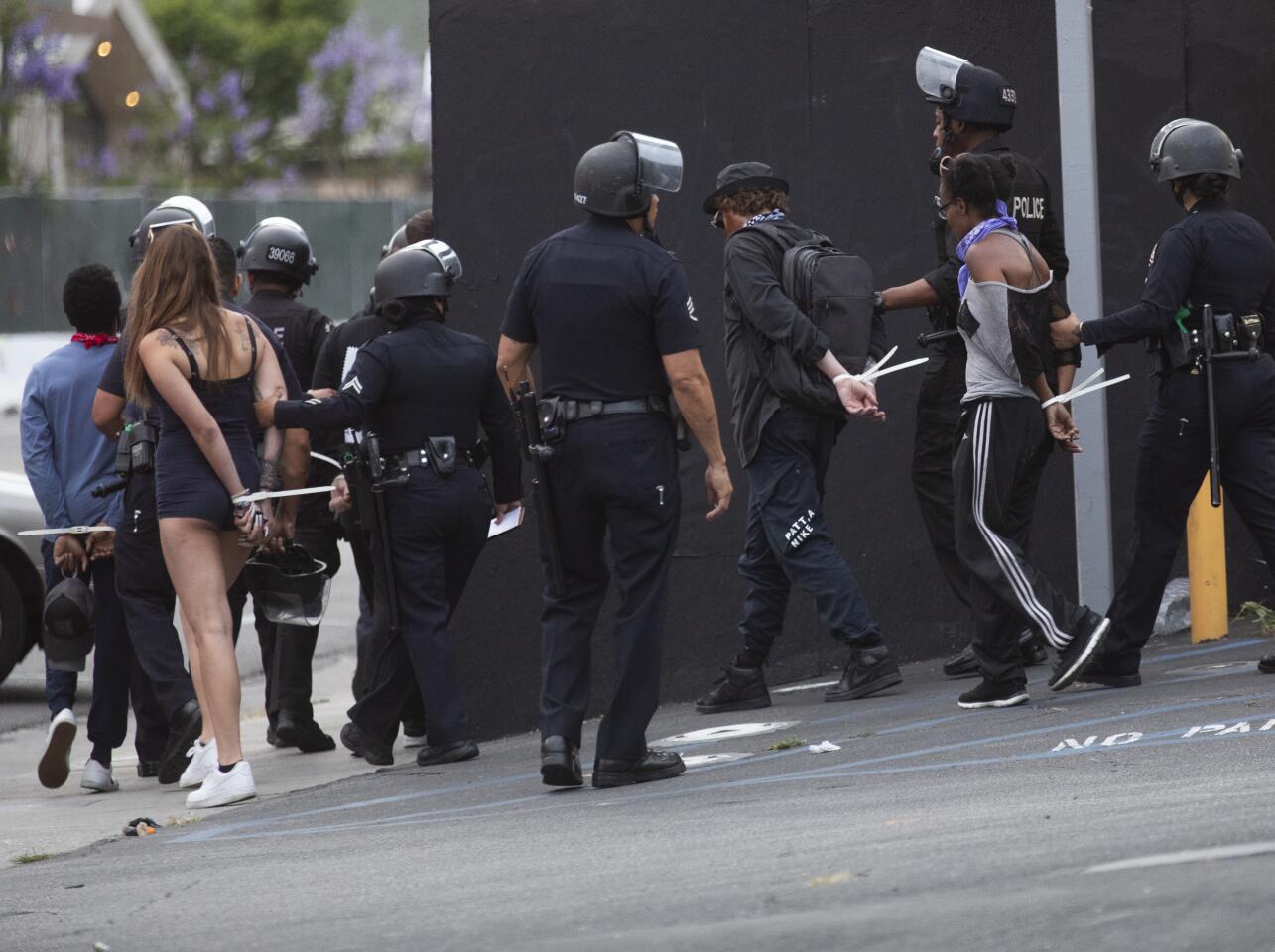 Arrests are made of those out after curfew in Hollywood.