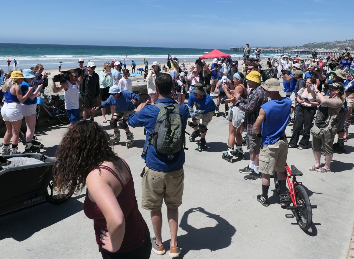 A large crowd gathered on the Pacific Beach Boardwalk to honor Dr. John "Slomo" Kitchin on his 80th birthday.