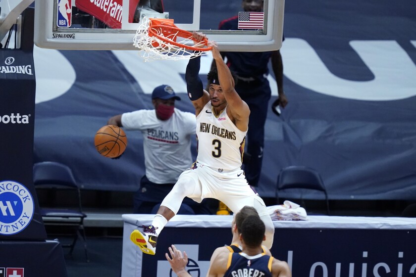 New Orleans Pelicans guard Josh Hart (3) slam-dunks over Utah Jazz center Rudy Gobert and forward Bojan Bogdanovic in the final seconds of the second half of an NBA basketball game in New Orleans, Monday, March 1, 2021. (AP Photo/Gerald Herbert)