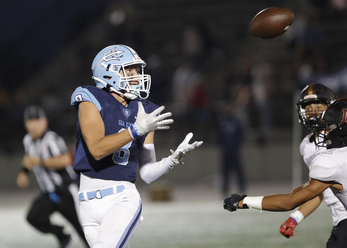 Corona del Mar receiver Russell Weir makes a catch in the open field during the Sea Kings' football opener against Downey.