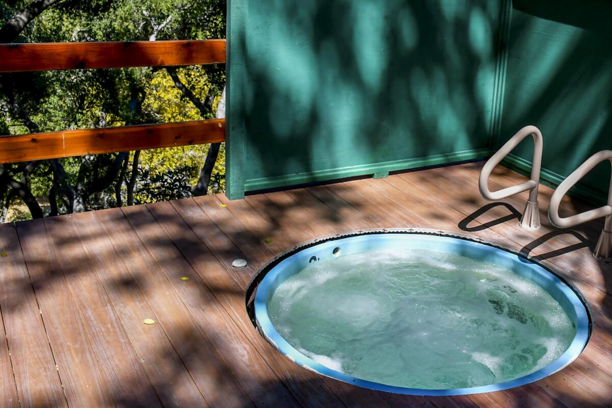 A round hot tub on a wooden balcony