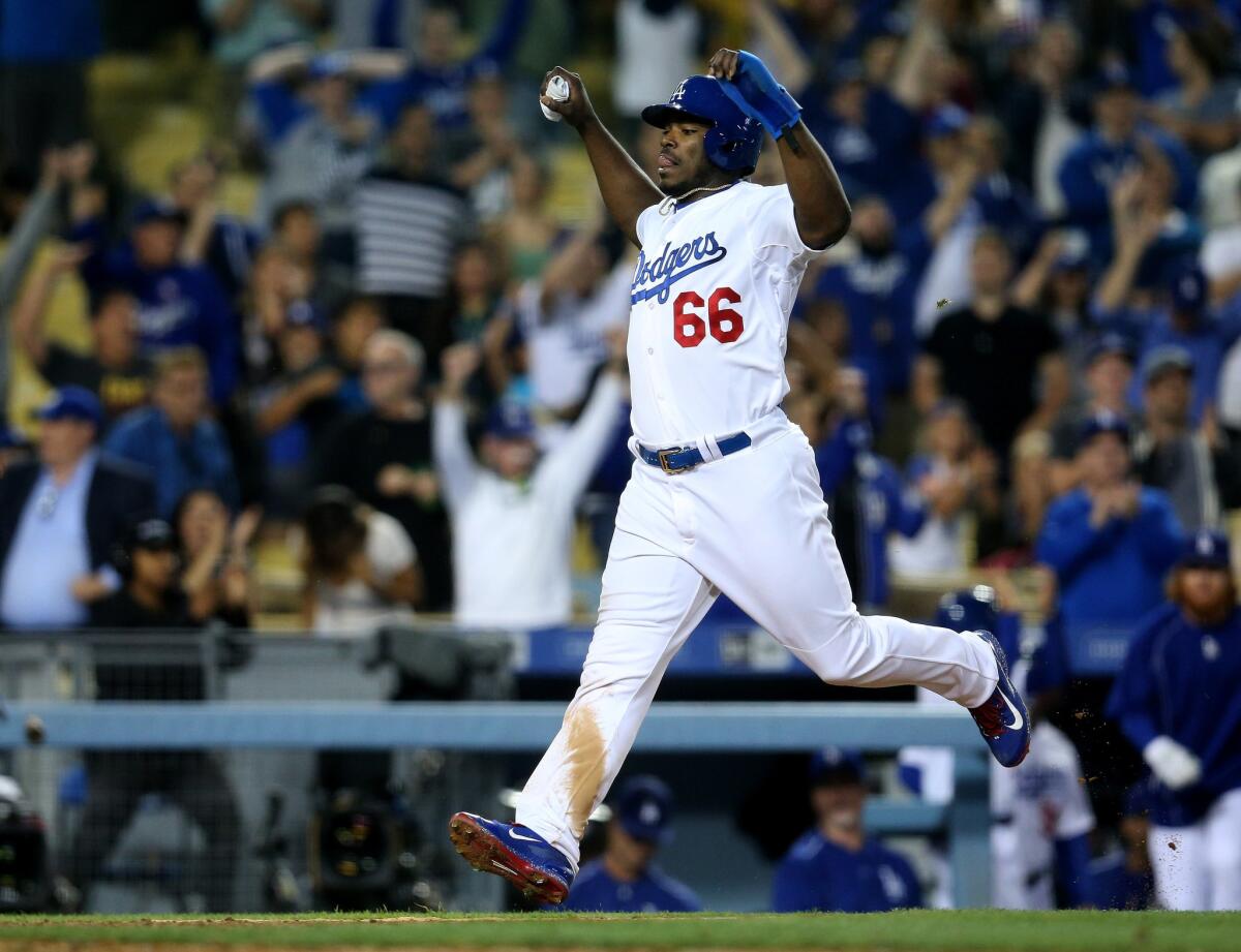 Dodgers outfielder Yasiel Puig celebrates as he runs home with the winning run on a walk-off single by Howie Kendrick.