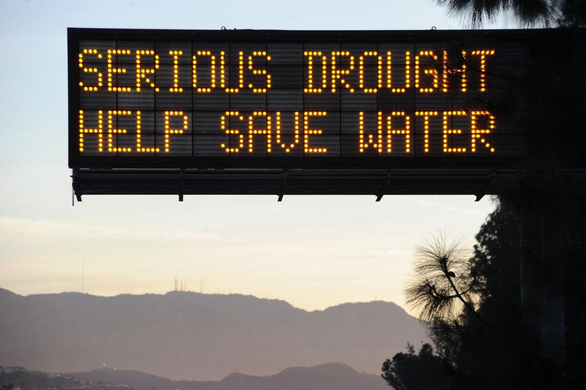 A sign over a highway in Glendale warns motorists to save water in response to the state's severe drought.