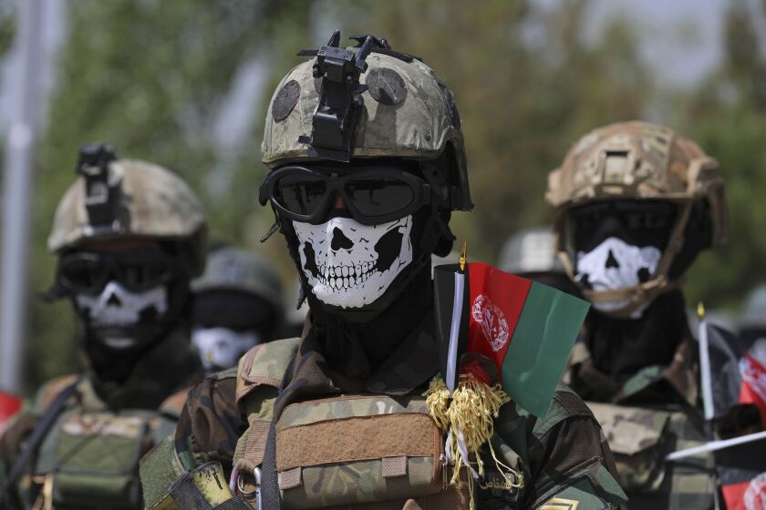 FILE - In this July 17, 2021 file photo, masked Afghan Army Special Forces attend their graduation ceremony after a three-month training program at the Kabul Military Training Center, in Kabul, Afghanistan. The US and NATO have promised to pay $4 billion a year until 2024 to finance Afghanistan’s military and security forces, which are struggling to contain an advancing Taliban. Already since 2001, the U.S. has spent nearly $89 billion to build, equip and train the forces. (AP Photo/Rahmat Gul, File)