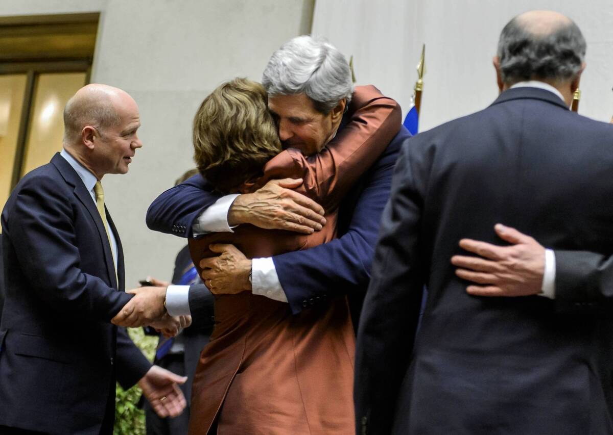 Diplomats in Geneva -- including U.S. Secretary of State John F. Kerry and European Union foreign policy chief Catherine Ashton, both seen above embracing -- celebrate the interim agreement with Iran on its nuclear program.