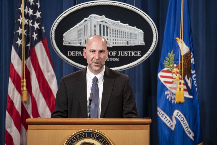 An FBI official speaks at a lectern.