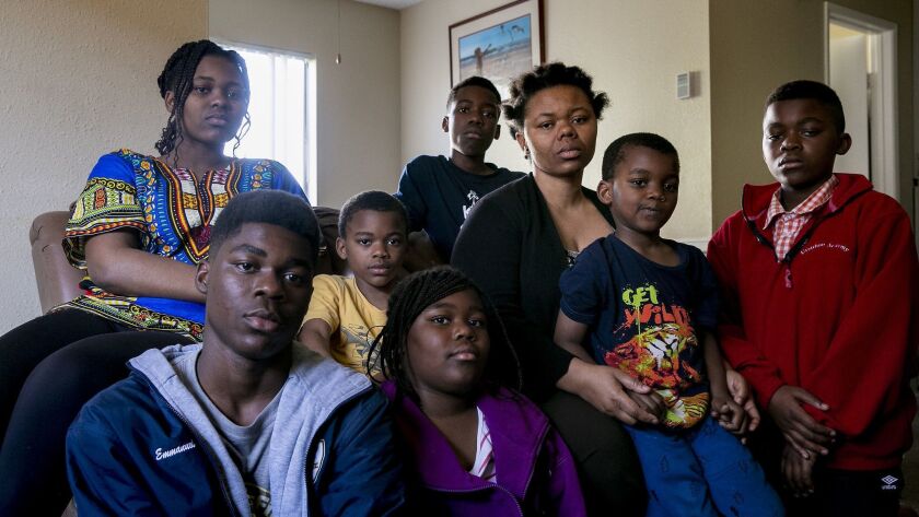 Annie Bwetu Kapongo, 37, poses for a portrait with her children inside their apartment in San Diego, California. She and her husband, Constantin Bakala, 48, came from the Democratic Republic of Congo to seek asylum.