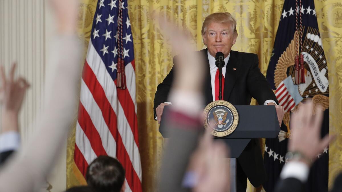 Reporters raise their hands as President Trump fields questions during a news conference at the White House on Feb. 16, 2017.