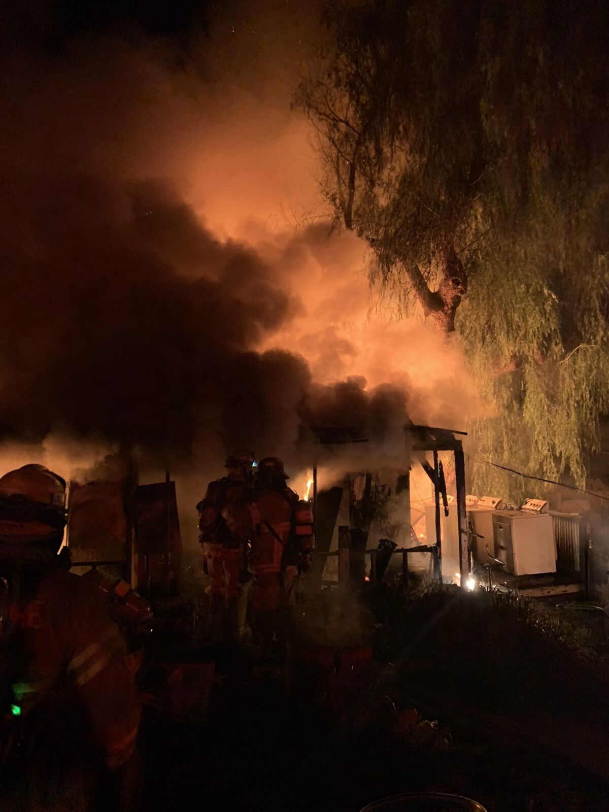 Firefighters battle a house fire early Monday morning in Ramona. Deborah Hester died inside the engulfed home.