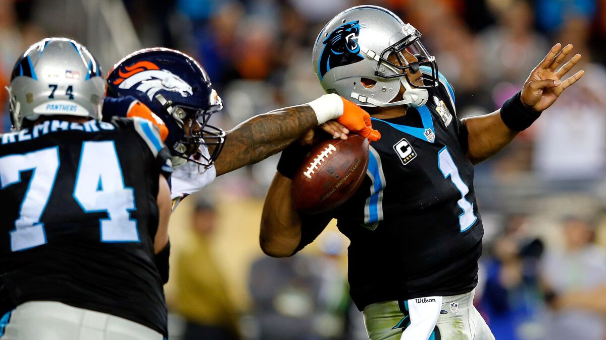 Broncos linebacker Von Miller (58) strips the ball from Panthers quarterback Cam Newton (1) during the fourth quarter.