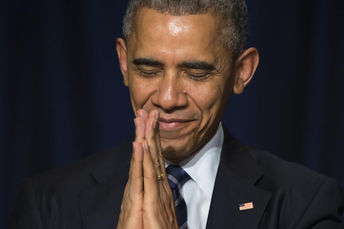 President Obama bows his head during the National Prayer Breakfast in Washington on Feb. 5.