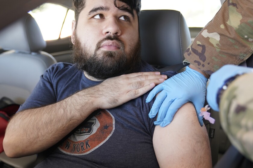 Social worker Jonathan De La Rosa gets a Pfizer COVID-19 vaccine booster shot in Mesquite, Texas.