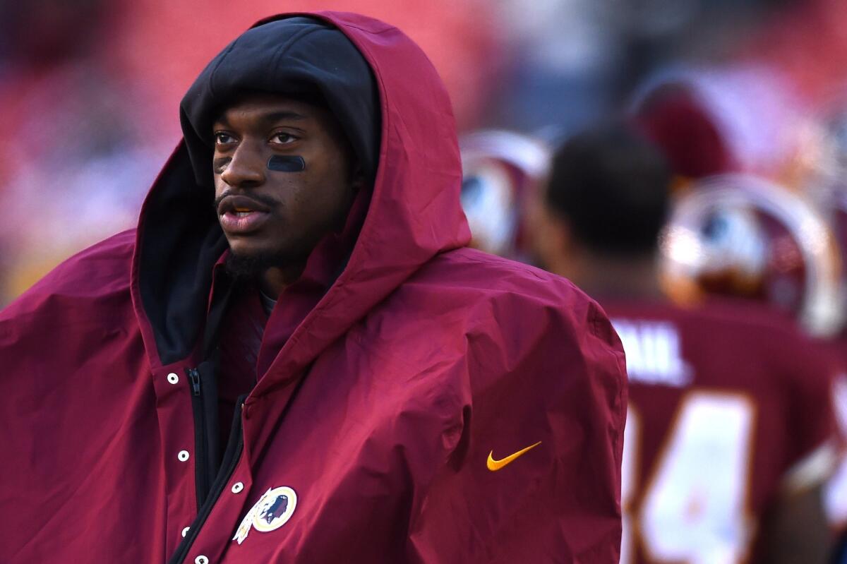 Washington's Robert Griffin III watches Sunday as the Redskins take on the St. Louis Rams at FedExField.