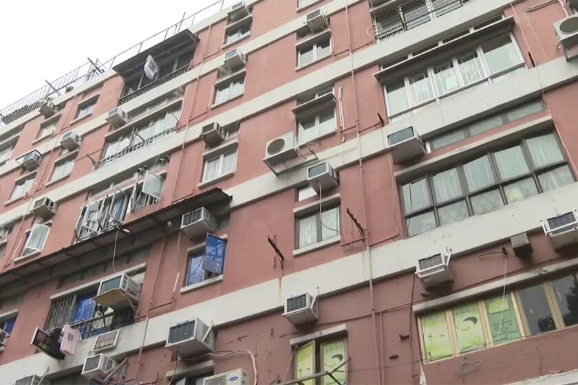 This image made from video shows an exterior of building where babies were found, Saturday, March 9, 2024. A cleaning person found two dead baby boys in glass bottles in the living room of a vacated apartment in Hong Kong, police said Saturday.(TVB via AP)