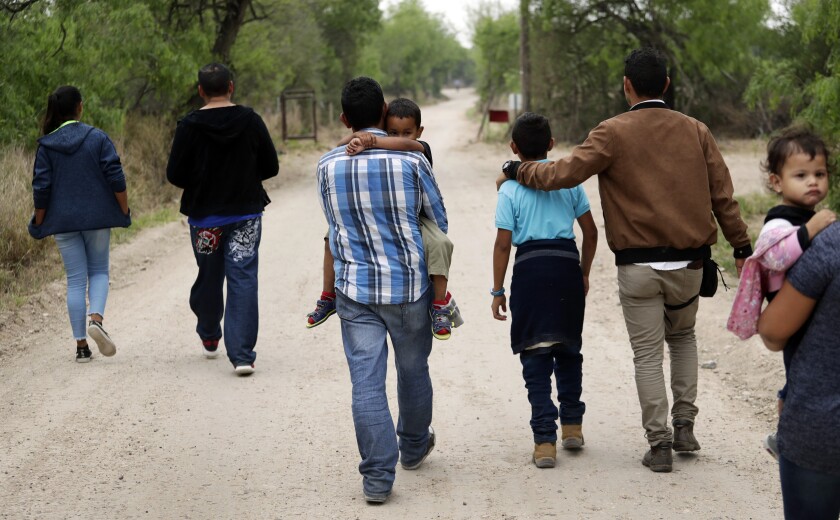 Migrant families walk from the Rio Grande in Texas in 2019. 