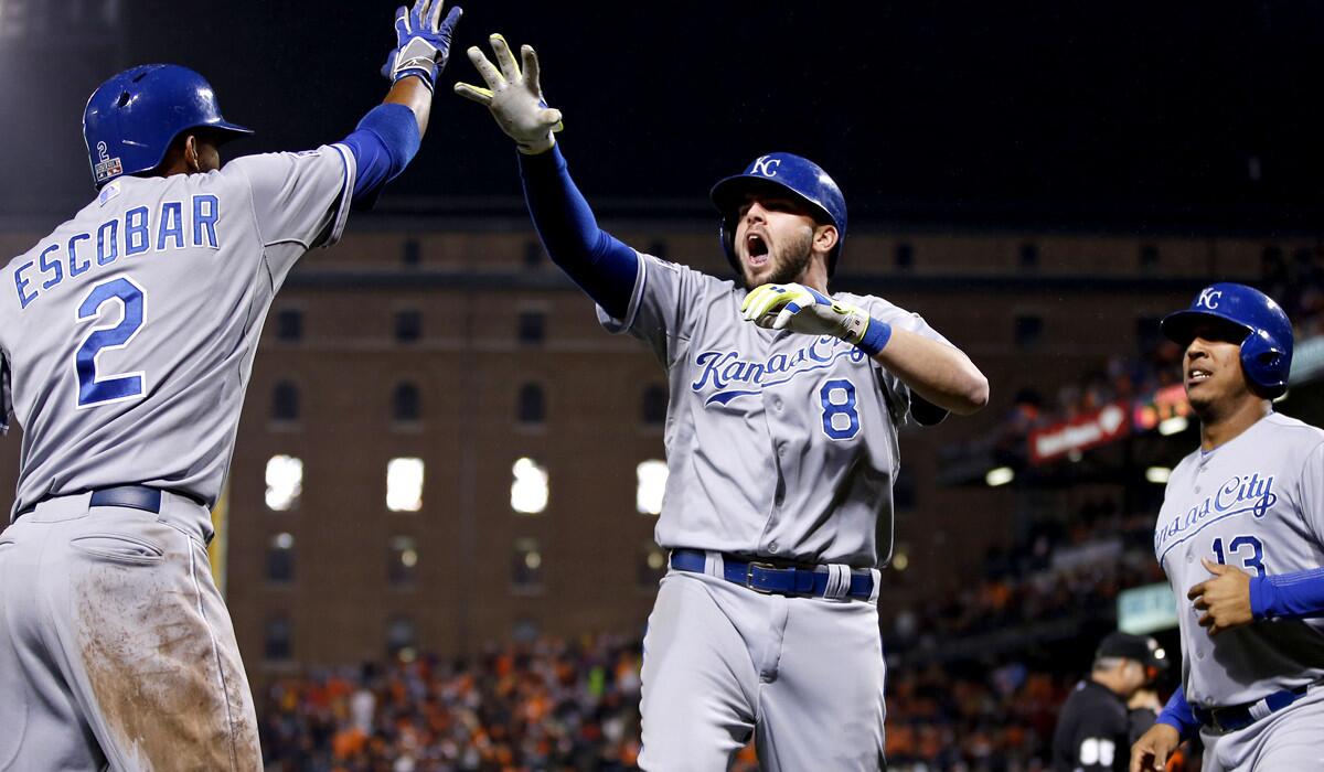 Royals third baseman Mike Moustakas (8) celebrates with teammates Alcides Escobar and Salvador Perez (13) after hitting a two-run home run that provided the winning margin in an 8-6 victory over the Orioles on Friday night.