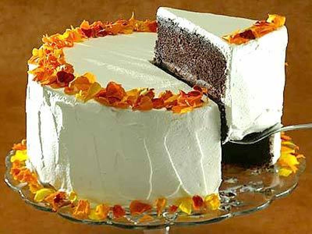 At the heart of the love goddess cake is a chocolate-chili powder filling with a subtle kick. The delicate cake, which has a touch of ancho powder as well, is iced with a lightly sweetened whipped cream frosting and decorated with flower petals.